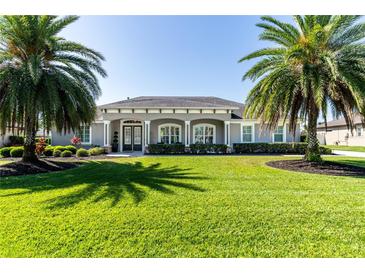 Stunning home featuring well-manicured lawn and mature palm trees for a relaxing curb appeal at 481 Sweet Bay Ave, New Smyrna Beach, FL 32168