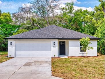 Charming single-story home features a clean white exterior, attached garage, and a neatly landscaped front yard at 808 Rosalia Dr, Sanford, FL 32771
