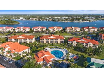Aerial view of waterfront condos with a community pool in a beautiful coastal setting at 445 Bouchelle Dr # 301, New Smyrna Beach, FL 32169