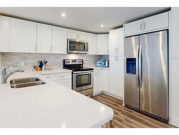 Bright kitchen featuring stainless steel appliances, white cabinets, and stylish countertop at 4752 S Atlantic Ave # 1, Ponce Inlet, FL 32127