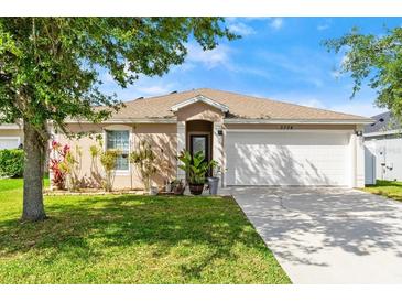 Charming single-story home with a well-manicured lawn and beautiful landscaping at 5304 Cordgrass Bend Ln, Port Orange, FL 32128