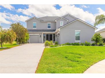 Charming two-story home with landscaped front yard, attached garage, and covered entryway at 6808 Forkmead Ln, Port Orange, FL 32128
