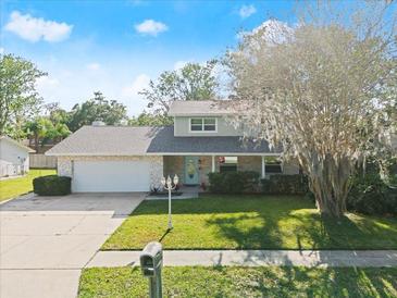 Charming two-story home with stone accents, well-manicured lawn, and mature trees in a desirable neighborhood at 3644 Dame St, Port Orange, FL 32129