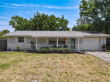 Charming single-story home with stone accents, mature trees and well-manicured landscaping at 836 6Th St, Port Orange, FL 32129
