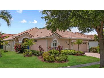 Beautiful one-story home featuring mature landscaping, a barrel tile roof, and neutral stucco siding at 11222 Rapallo Ln, Windermere, FL 34786