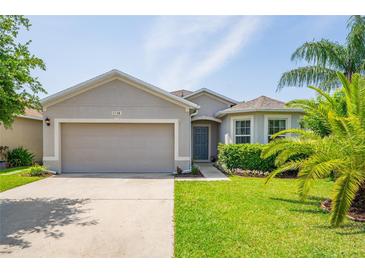 Charming single-story home featuring a well-manicured lawn and attached two-car garage at 1748 Savannah Ln, Port Orange, FL 32128