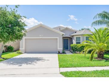 Charming single-story home featuring a well-manicured lawn and a two-car garage at 1748 Savannah Ln, Port Orange, FL 32128