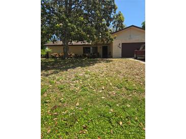 Charming single-story home with a well-maintained lawn and mature trees, perfect for a peaceful suburban lifestyle at 2725 Travelers Palm Dr, Edgewater, FL 32141
