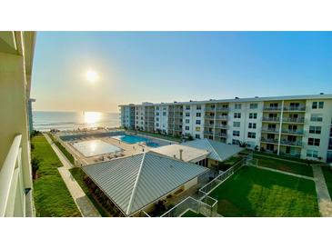 A picturesque beachfront resort with a pool, sun deck, and expansive ocean views at 4151 S Atlantic Ave # 414, New Smyrna Beach, FL 32169
