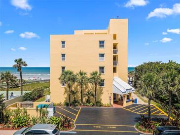 Oceanfront building features a private beach access, covered parking and tropical landscaping at 425 S Atlantic Ave # 302, New Smyrna Beach, FL 32169