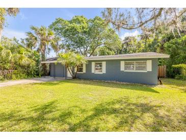Charming single-story home with a well-maintained lawn and mature landscaping at 431 Palmetto St, Edgewater, FL 32132