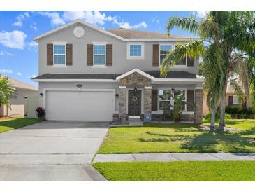 Charming two-story home features a stone-accented entrance, a two-car garage, and a well-manicured lawn at 5337 Royal Plantation Blvd, Port Orange, FL 32128