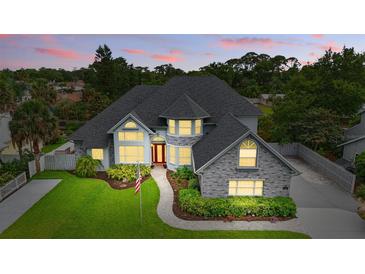 Gorgeous two-story home with landscaped front yard, gray brick accents and a inviting entryway at 128 Godfrey Rd, Edgewater, FL 32141