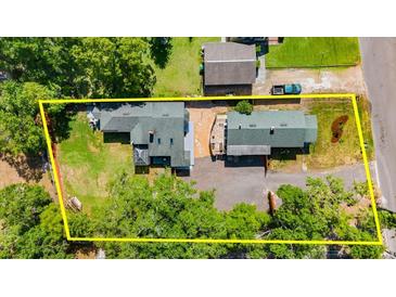 Aerial view of the property showcasing the houses, landscaping, and the layout of the yard at 135 12Th St, Daytona Beach, FL 32117