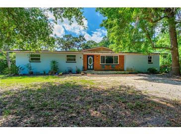 Charming one-story home with brick accents, blue door, blue siding and a spacious front yard at 1786 Taylor Rd, Port Orange, FL 32128