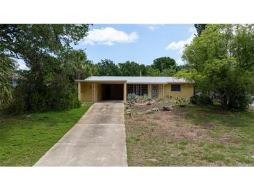 Charming one-story home featuring a covered carport and unique, drought-tolerant landscaping at 2107 Saxon Dr, New Smyrna Beach, FL 32169