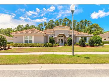 Charming single-story home featuring a barrel tile roof and well-manicured landscaping at 260 Portofino Blvd, New Smyrna Beach, FL 32168