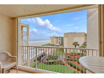 Lovely balcony view of the beach, pool, and manicured garden at this oceanfront condominium complex with a great view at 4175 S Atlantic Ave # 4050, New Smyrna Beach, FL 32169