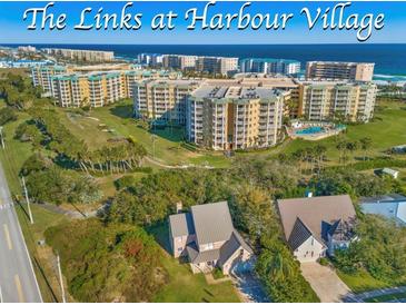 Beautiful Harbour Village condos with lush green trees in a scenic coastal community at 4670 Links Village Dr # D206, Ponce Inlet, FL 32127