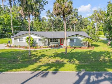 Charming single-story home with manicured lawn and mature trees at 1144 Corbin Park Rd, New Smyrna Beach, FL 32168