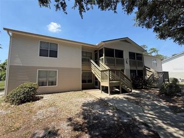 The exterior of a two-story home with patios and wood stairs is beautifully designed at 1600 Big Tree Rd # L1, South Daytona, FL 32119