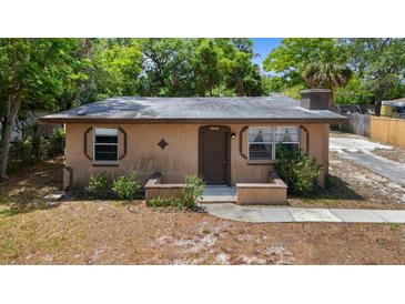 Charming single-story home featuring a cozy front porch and natural landscaping at 1718 Maryland Ave, Ormond Beach, FL 32174