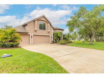 Charming home with a three car garage, nice landscaping, and a well-manicured lawn at 1734 Covendale Ln, Port Orange, FL 32128