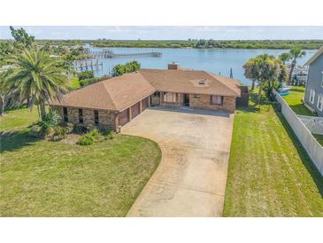 Stunning waterfront home with a private dock and lush landscaping at 1905 S Riverside Dr, Edgewater, FL 32141