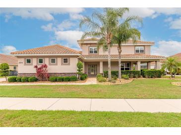 Charming two-story home with well-maintained landscaping and beautiful terracotta tiled roof at 254 Cappella Ct, New Smyrna Beach, FL 32168