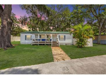Charming single-story home with a covered front porch and lush green lawn at 2917 Crockett Pt, Sanford, FL 32773