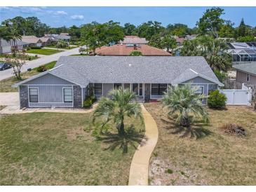 Charming single-story home boasts lush landscaping, a well-manicured lawn, and a welcoming walkway at 7 Heather Ln, Ormond Beach, FL 32174