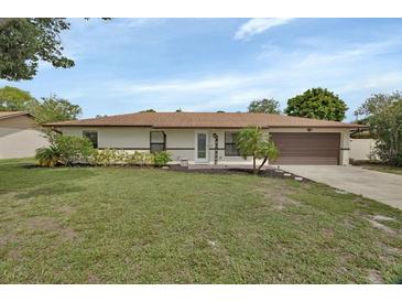 Charming ranch-style home featuring a well-manicured lawn and a welcoming front entrance at 1382 Coronet Dr, Deltona, FL 32725