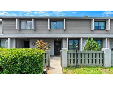 Charming two-story home with a well-maintained front yard, featuring a gray facade, decorative plants and new landscaping at 140 Limewood Pl # C, Ormond Beach, FL 32174