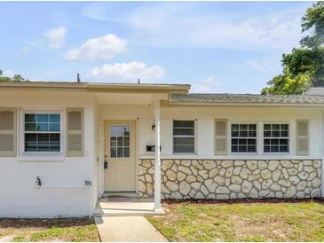 Charming single-story home featuring a stone accent wall and a welcoming front porch entrance at 167 N Hill Ave # 60, Deland, FL 32724