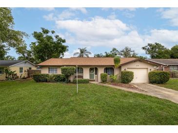 Charming single-story home with a well-manicured lawn, lush landscaping, and inviting curb appeal at 210 Delespine Dr, Debary, FL 32713