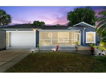 Charming single-story home with a well-manicured lawn and a screened lanai, perfect for enjoying the outdoors at 2325 Lime Tree Dr, Edgewater, FL 32141