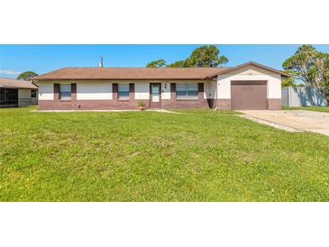 Charming single-story home with a well-maintained lawn, brown accents, and an attached garage at 3044 Pine Tree Dr, Edgewater, FL 32141