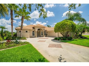 Beautiful single-story home with lush landscaping and a circular driveway with decorative brick accents at 3577 Maribella Dr, New Smyrna Beach, FL 32168