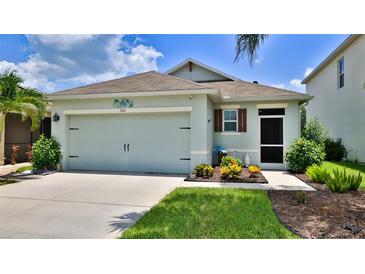 Charming single-story home featuring a two-car garage and well-maintained landscaping at 551 Armoyan Way, New Smyrna Beach, FL 32168