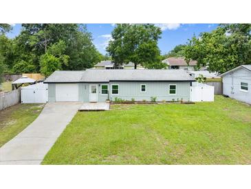 Charming single-story home featuring a well-manicured lawn, attached garage, and sidewalk leading to the front door at 680 Buford Ave, Orange City, FL 32763