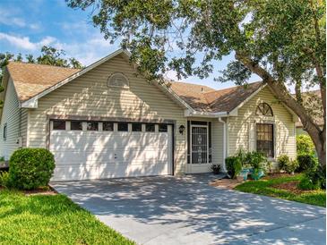 Charming single-story home with a well-manicured lawn, two-car garage, and beautiful mature trees, providing shade and curb appeal at 686 Middlebury Loop, New Smyrna Beach, FL 32168
