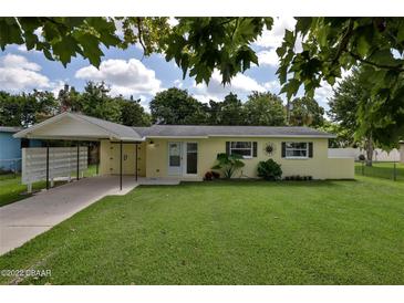 Charming single-story home with a covered carport and a well-maintained lawn at 2009 Brian Ave, South Daytona, FL 32119