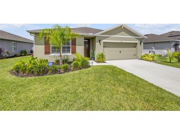 Inviting single-story home featuring a lush green lawn, well-manicured landscaping, and a charming front entrance at 2731 Neverland Dr, New Smyrna Beach, FL 32168
