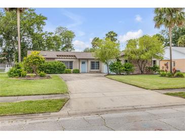 Charming single-story home with a well-maintained lawn, a light blue door and plenty of curb appeal at 357 Hearthstone Ter, Port Orange, FL 32127