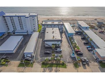 Aerial view of condo building and its proximity to a beautiful sandy beach at 3615 S Atlantic Ave # 211, Daytona Beach, FL 32118