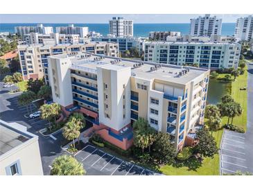 Condo building with balconies overlooking ocean, parking, & green space in a coastal community at 5300 S Atlantic Ave # 11302, New Smyrna Beach, FL 32169