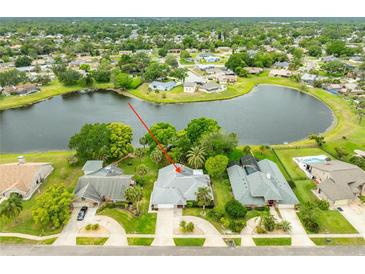 Beautiful aerial view of a home with lush landscaping and a tranquil lake in a desirable neighborhood at 757 Hunt Club Trl, Port Orange, FL 32127