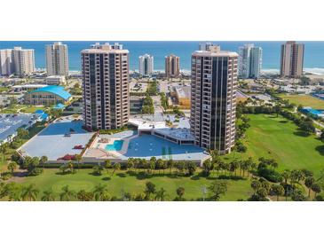 A stunning aerial view of the beachfront condo community, featuring lush landscaping, pool and ocean views at 1 Oceans West Blvd # 1B5, Daytona Beach, FL 32118