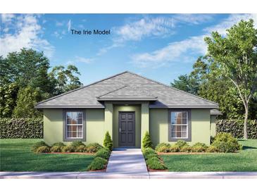 Charming single-story home featuring a well-manicured lawn and neutral-toned facade with a gray roof at 1042 Gary Blvd, Daytona Beach, FL 32119