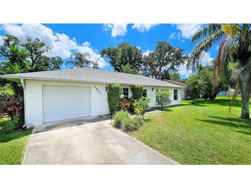 Charming single-story home with a well-maintained lawn and mature trees at 1903 Willow Oak Dr, Edgewater, FL 32141